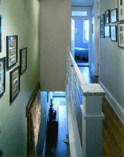 The upstairs hallway got a new coat of low-VOC paint, and the newel post was capped with Vetrazzo, made with recycled glass.